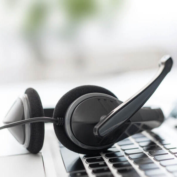 Ein Headset liegt auf der Tastatur eines Laptops